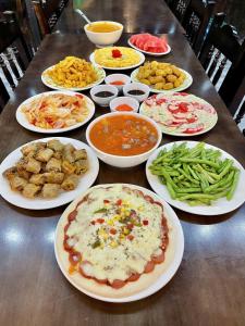 a table with many plates of food on it at Van Anh Hotel - Restaurant in Dồng Văn