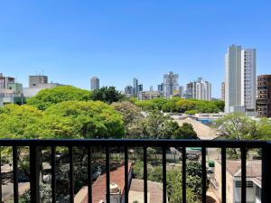 a view of a city skyline from a balcony at Aptos 1 ou 2 quartos no Centro com Piscina e Academia in Maringá