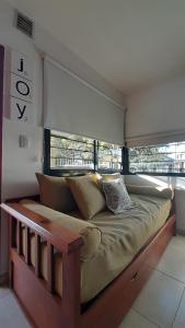a large bed in a room with a window at Duplex Villa Carlos Paz in Villa Carlos Paz