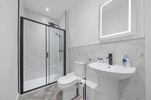 a bathroom with a toilet and a sink and a shower at Spacious 2 Bed Apartment - Perfect for Long or Short Stays - Sleeps 4 - Free On Street Parking in Fife