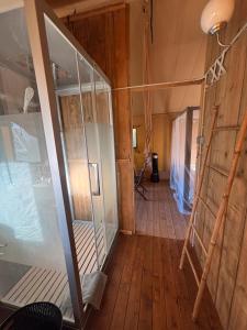 an empty room with a glass door in a house at Lodge La Forêt in Saint-Sauveur