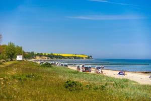 a beach with chairs and people on the sand at Kastanienhof Whg 07 in Boltenhagen