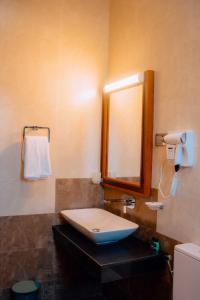 a bathroom with a sink and a mirror at Kings Town Hotel Anuradhapura in Nikawatawana +38 photos