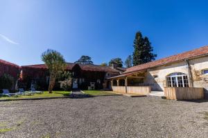 an exterior view of a building with a gravel driveway at Au p'tit tcheste in Hontanx