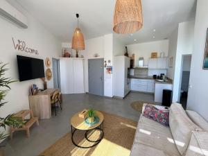 a living room with a couch and a table at Bel appartement avec piscine en bord de mer in Ajaccio