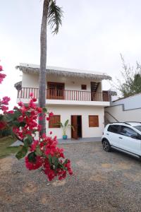 a house with a car parked in front of it at Casa da GabiLu in Itapipoca
