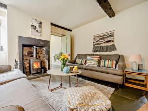 a living room with a couch and a fireplace at 4 Bed in Buttermere SZ090 in Buttermere