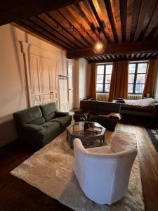 a living room with a couch and a table at Maison intra muros in Langres +12 photos