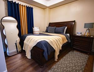 a bedroom with a bed and a dresser and a mirror at 3 Bdr Apartment close to Port of Spain in Diego Martin +19 photos