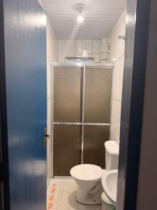 a bathroom with a shower with a toilet and a sink at Pousada São José in Itatiaia +8 photos