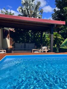 a swimming pool in front of a house at Villa AGADA GUEST HOUSE ONLY ADULT in Vieux-Fort