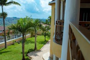 a view from a balcony of a building with palm trees at Elegant Villa Apart in Kigali