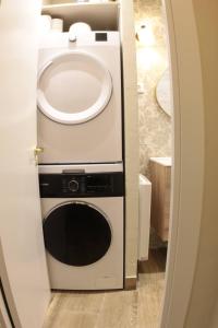 a bathroom with a sink and a washer and dryer at Piedra y Luz in Buendía