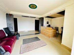 a living room with a couch and a desk at Sunrise Resort in Araku +9 photos