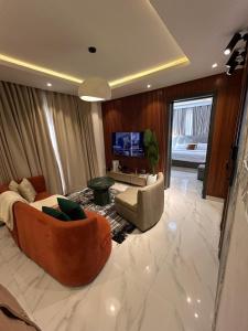 a large living room with a couch and a tv at Rorex cozy cityview 1 bedroom apartment in Lekki