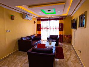 a living room with a couch and a table at Applegate Hotel in Yaoundé