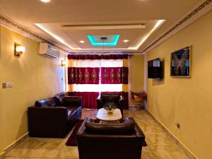 a living room with a couch and a table at Applegate Hotel in Yaoundé