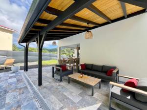 a living room with a couch and a table at Villa Aloha - classée 5 étoiles - avec piscine in Les Trois-Îlets