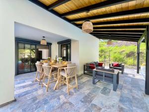 a dining room with a table and chairs at Villa Aloha - classée 5 étoiles - avec piscine in Les Trois-Îlets