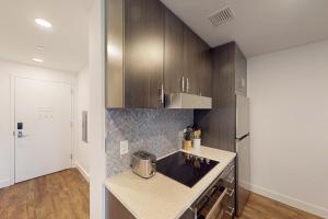 a kitchen with wooden cabinets and a counter top at Pioche Village - #1230 in Cranmer +12 photos