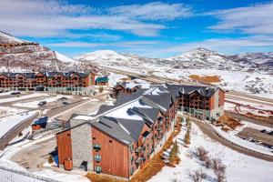 an aerial view of a resort with snow covered mountains at Pioche Village - #1230 in Cranmer