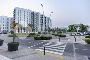 an empty street in a city with tall buildings at Bloomfields Comfortable 1Br In Water Edge in Yas Island