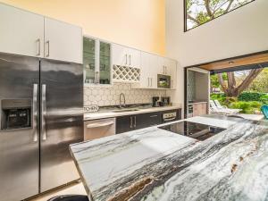 a large kitchen with a stainless steel refrigerator at The Wave House in Santa Cruz
