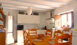 a kitchen with a table and a kitchen with a refrigerator at Brisa in Oria