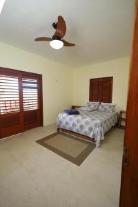 a bedroom with a bed and a ceiling fan at Casa da GabiLu in Itapipoca +32 photos