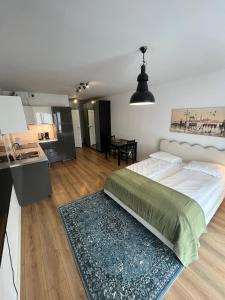 une chambre avec un grand lit et une cuisine dans l'établissement Fred&Moris Apartments, à Poznań 57 autres photos