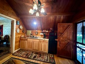 a kitchen with wooden cabinets and a black refrigerator at Big Bear Log cabin in Cosby +13 photos