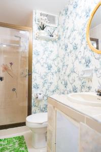 a bathroom with a toilet and a sink and a shower at Casa MIKONOS in Cartagena de Indias +53 photos