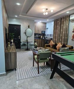 un soggiorno con un tavolo da biliardo e un divano di Smartcribs 1 Bedroom Solar Powered Apartment, GRA a Port Harcourt