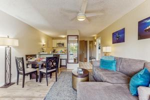 a living room with a couch and a table at Plantation Hale D10 in Kapaa