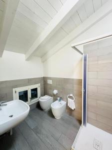a bathroom with two sinks and a toilet and a shower at Giardini B&B in Modena +38 photos