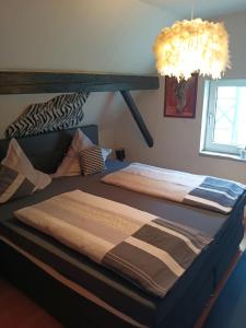 a bedroom with two beds and a chandelier at Ferienhaus Olsberg in Olsberg