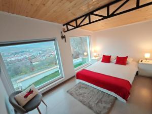 a bedroom with a bed and a large window at Epic Glamping in Călimăneşti