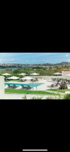 a large swimming pool with tables and umbrellas at Escapes in Simpson Bay