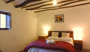 a bedroom with a bed with two stuffed animals on it at Brisa in Oria