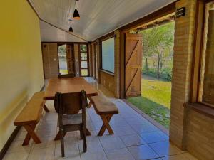 ein Esszimmer mit einem Holztisch und einem Stuhl in der Unterkunft Casa na serra da Mantiqueira in São José dos Campos + 24 Fotos