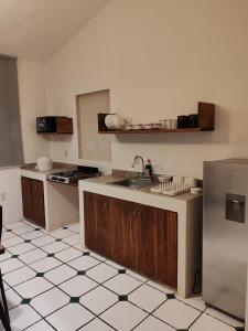 a kitchen with a sink and a refrigerator at Casa Xico 424- Centro, Xicotepec, Puenlo Magico in Xicotepec de Juárez +35 photos
