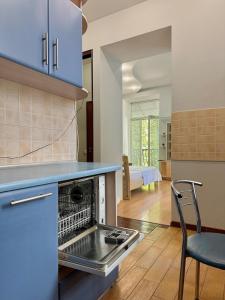 a kitchen with a stove top oven next to a table at 1 room right near the Kreschatyk in Kyiv