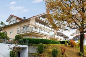 a large house with a fence in front of it at Ferienwohnung Baier in Überlingen