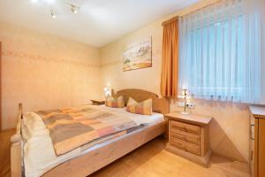 a bedroom with a large bed and a window at Ferienwohnung Baier in Überlingen