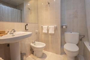 a bathroom with a toilet and a sink at Hotel Encamp by Nexta in Encamp +19 photos