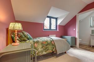 a bedroom with a bed and a table with a lamp at Kim's Place in Hingham