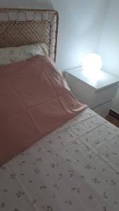 a bed with a blanket and a nightstand next to a bed at Margareth suite and terrace in San Lucido