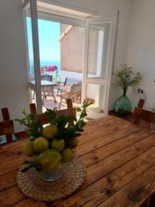 a bowl of fruit on a wooden table in a room at Margareth suite and terrace in San Lucido