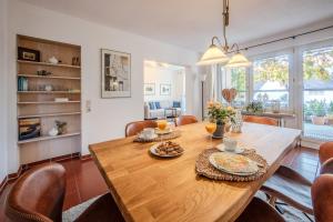 ein Esszimmer mit einem Holztisch und Stühlen in der Unterkunft Jolie's Cottage in Iznang