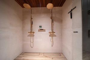 a bathroom with two lights and a shower at Villa Lumi 2 Levi in Kittilä